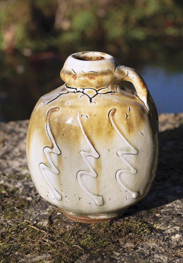 3 One-handled flattened bottle, 5 in. (13 cm) in height, peat clay, ash glaze with river iron.