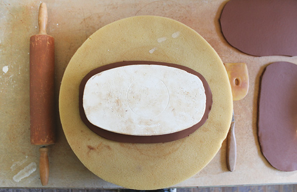 5 Position your mold on top of your foam padding and in the center of your cut slab. After pressing downward, the slab will conform to the shape of the plaster.