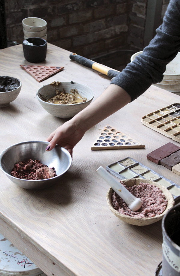 6 Powell arranging test tiles for a materials workshop at Studio Alluvium.