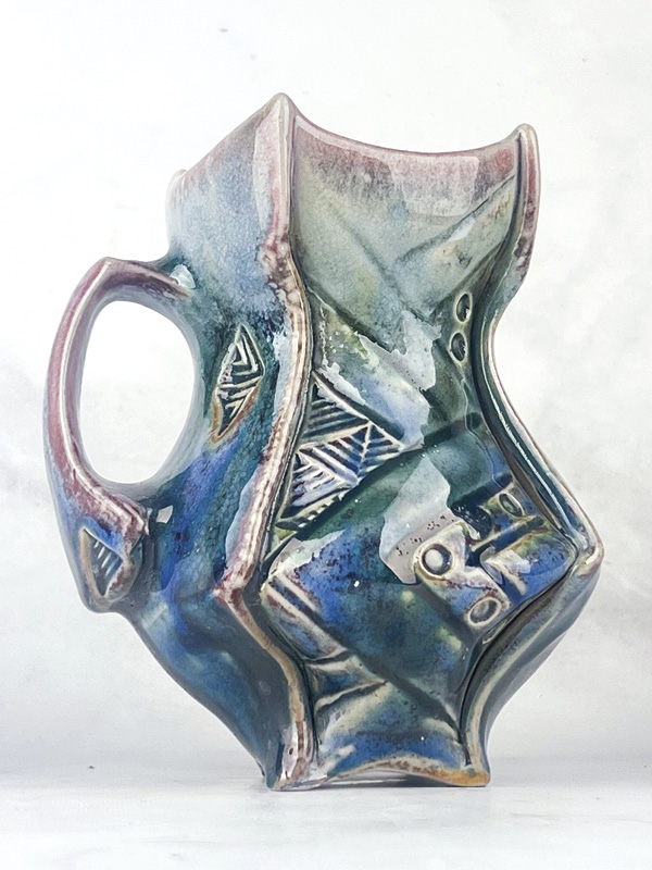 Samuel Newman's Glacier Maker’s Mug, 5½ in. (14 cm) in height, Laguna B-Mix 10 (porcelaneous stoneware), thin spray of Tenmoku, Galactic Indifference sprayed as a second layer, fired in reduction to cone 12 in a soda kiln, 2024.