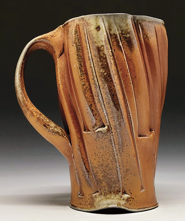 3 Ben Eberle's Tall mug, 6½ in. (15.2 cm) in height, wheel-thrown, embossed, and stretched B-Mix clay, fired to cone 10 in a wood-soda kiln, 2024.