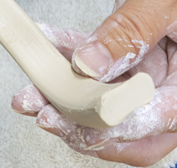 2 Pull the handles so they are rectangular. The broad sides will keep the handles from being too fragile and the narrower edges serve as a canvas for slip trailing and glaze decoration.