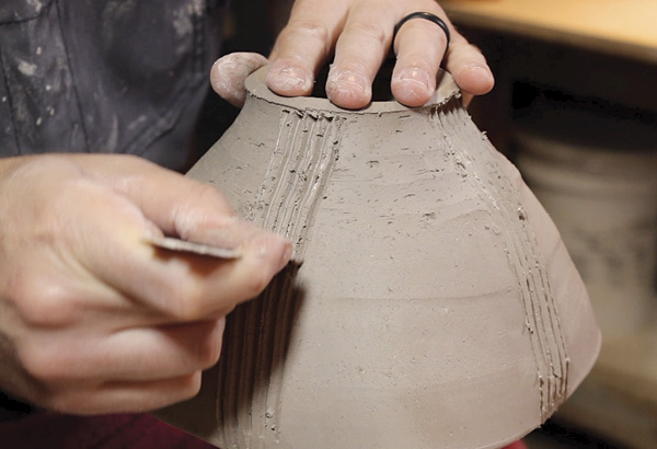 6 Using the same tiling trowel from earlier, redraw the lines that have been carved away by the trimming process.