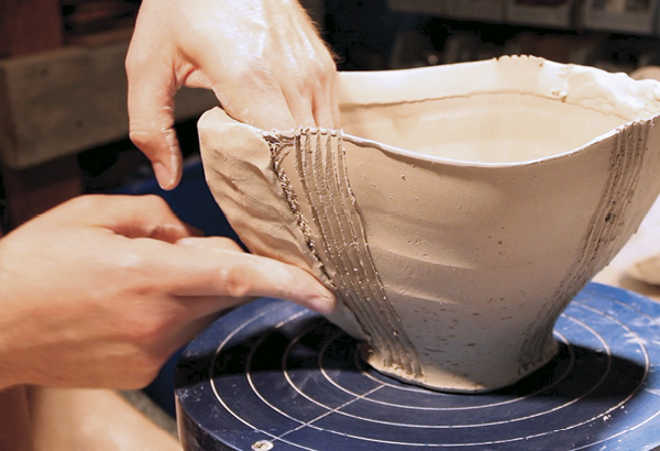 10 Spend a significant amount of time compressing the wedge of clay into the side of the bowl with your thumb and fingers. Repeat steps on the opposite side of the bowl to balance the piece.