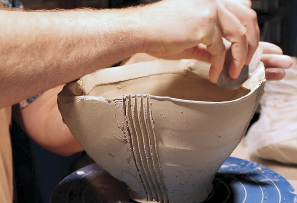 14 Using a metal rib, compress and smooth out the additive coil to match the existing rim of the bowl.