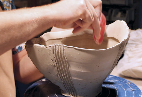 16 Continue to refine the added clay by going over it with a silicone rib, paying close attention to the underside connection point between the interior of the bowl and the rim.
