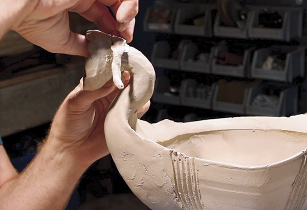 20 Rolling out a small coil, reinforce the connection between the neck of the ale bowl and the pinched bowl that will become the head of the finial. Be sure to use additional clay as needed to smooth out the transition between the neck and head.