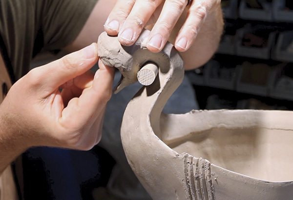 21 Using a series of small coils, blend them into the head of the finial using your thumb and forefinger. Make sure that you have enough room to place the eye later.