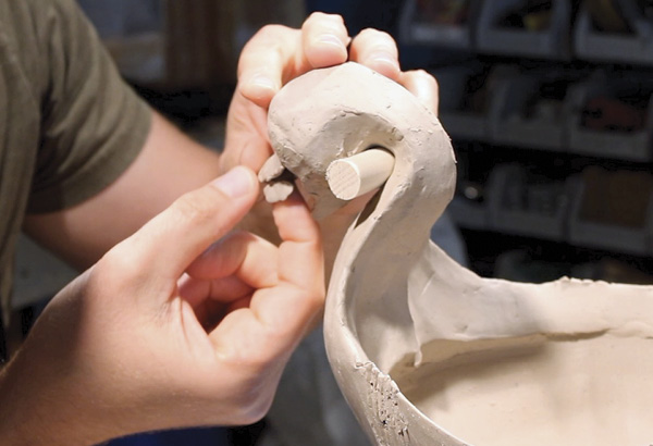 23 Pinch out a very small coil. Score, slip, and attach this additional clay to the upper jaw to create the upper lip. Make sure that you have enough room to be able to place a tongue, teeth, or other details you wish to add to your head.
