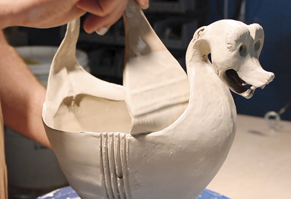 24 After constructing the finial head(s), allow the piece to dry overnight under plastic and then apply three coats of white slip to the work. Allow the slip to dry after each layer.