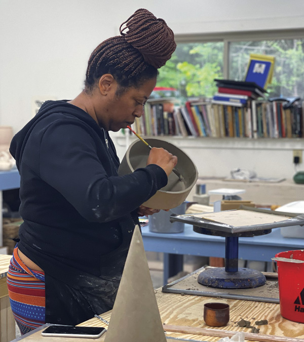 5 Stefani Threet handbuilding in the communal ceramics studio. Photo: Hambidge Center staff.