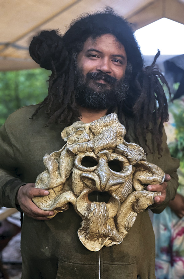 8 Dom Venzant displaying a newly unloaded wood-fired piece by Bobby Scroggins. Photo: Hambidge Center staff.
