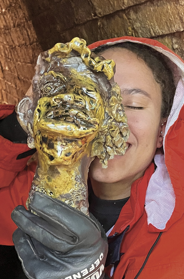 11 Kemi Schleicher displaying a newly unloaded wood-fired piece by Sharon Norwood. Photo: Addis Alemu.