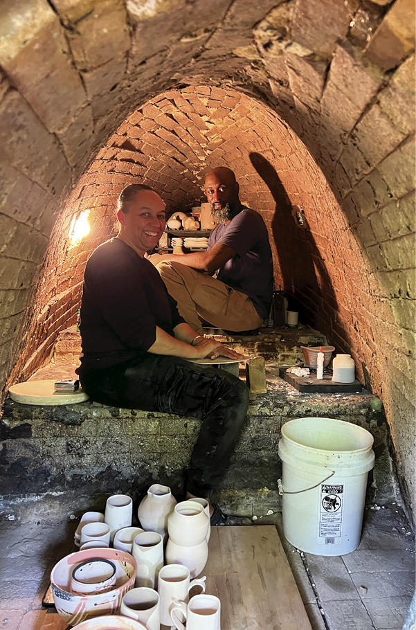 12 Ife Williams and Rich Brown loading the anagama kiln. Photo: Hambidge Center staff.