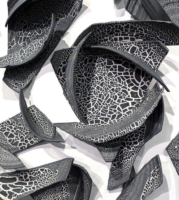 1 Monica Rudquist’s Murmuration (detail), 102 ft. (31.1 m) in length, porcelain, black crackle glaze, fired in oxidation to cone 10 in gas and electric kilns, 2024.