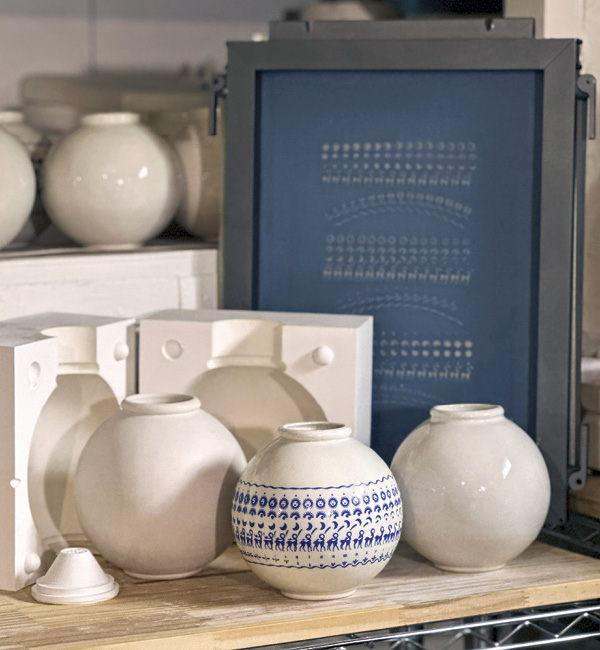 2 Vessels in various stages of production, plaster molds, and silkscreen for printing decals.