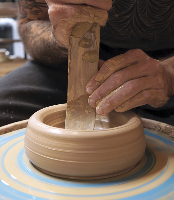 1 Start by centering roughly 3 pounds (1.4 kg) of clay.
