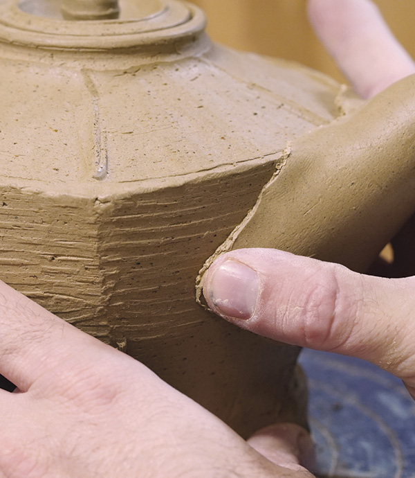 12 Cut material away from the back of the spout in an arch shape to find the right fit.