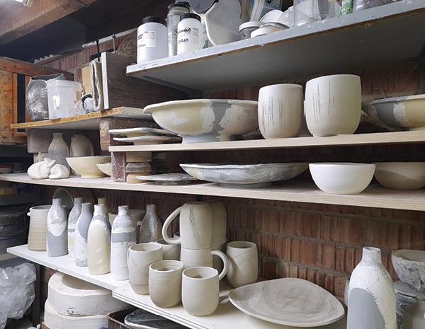 7 Full shelves of drying work in the studio.