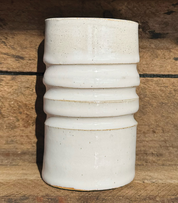 2 Allie Covert’s small cup, 4¼ in. (11 cm) in height, Standard Clay’s 553 Warm Buff Clay, MQP Maggie’s White glaze, fired to cone 6 in oxidation.