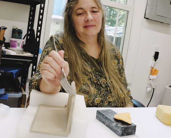 2 Hintgen uses an empty box and packing corners to hold up pieces while handbuilding.