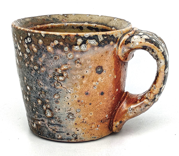 1 A mug made to resemble the traditional Shigaraki finish. Rotted granite sand from Richmond, Virgina, was wedged into the clay.