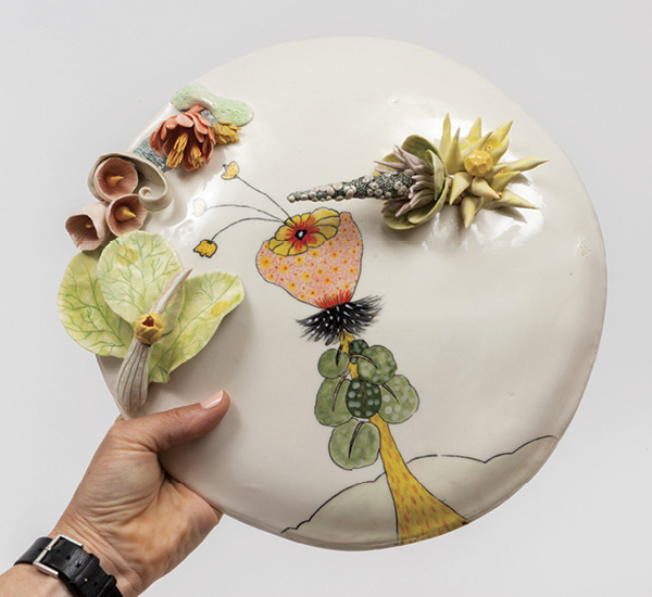Marney McDiarmid's finished artwork being held in one hand.