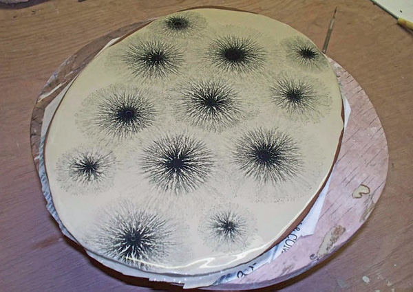 3 Black dendritic tree slip pattern drying on an oval platter.