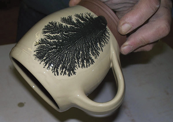 4 Tree pattern on cup, fired in oxidation to cone 04.