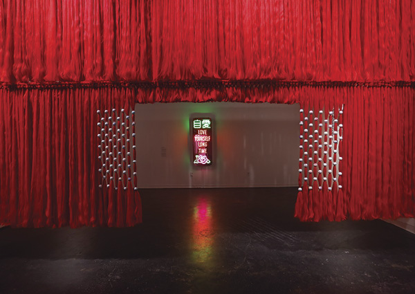 6 Background: Jennifer Ling Datchuk’s Love Yourself Long Time. Foreground: Jennifer Ling Datchuk’s thick; 22 ft. (6.7 m) in length; synthetic hair; porcelain beads from Jingdezhen, China; 2021.