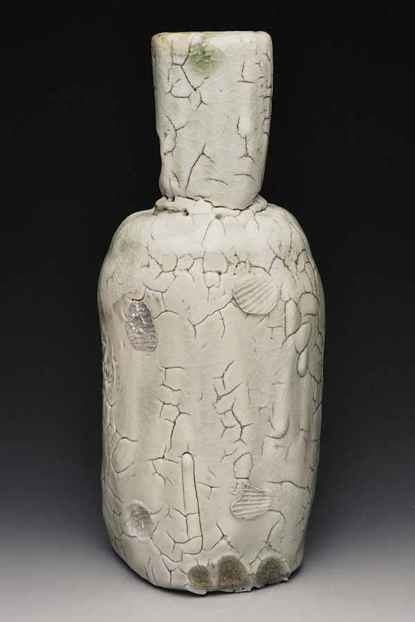 1 Carey Nathanson’s white bottle, 11 in. (28 cm) in height, wood-fired stoneware, shino glaze, 2024.