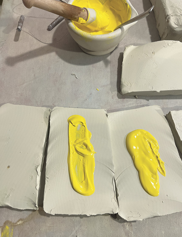2 Cut the clay into a number of cross-sections and smear the stain paste on one side of each cross-section.