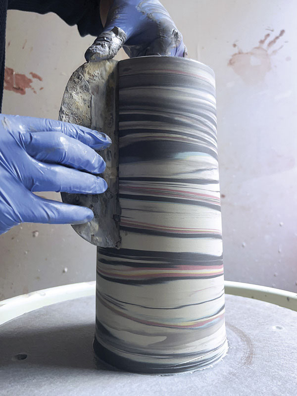 13 Use a metal rib to remove slip and reveal agateware pattern after pulling.
