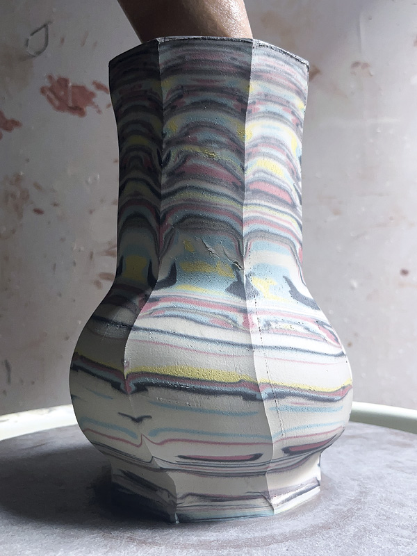 18 Use a wooden rib with rounded edges to shape the pot from the inside.