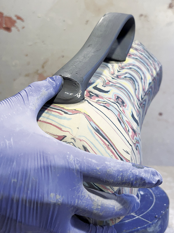 24 Run a wet thumb back and forth at the bottom of the handle to create a groove, which serves as a visual anchor.