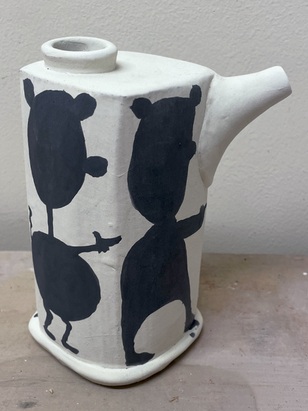 6 Add two coats of black underglaze to lay out silhouettes.