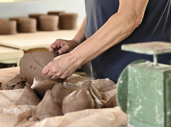 8 Fagella weighing and wedging clay before a throwing session.