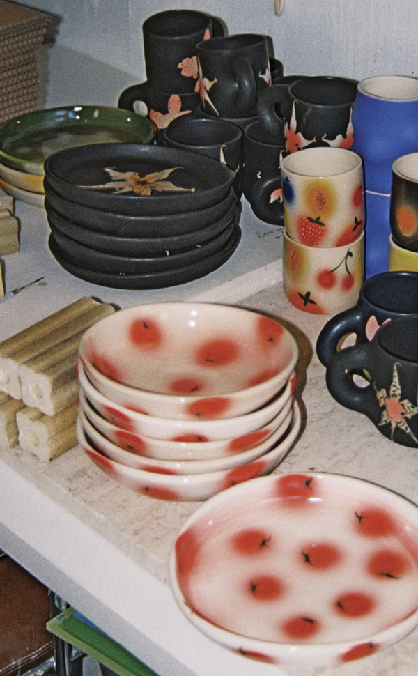 8 Wheeler’s desk covered in freshly glaze-fired work. Photo: Kris Hayden (@parallelparking).