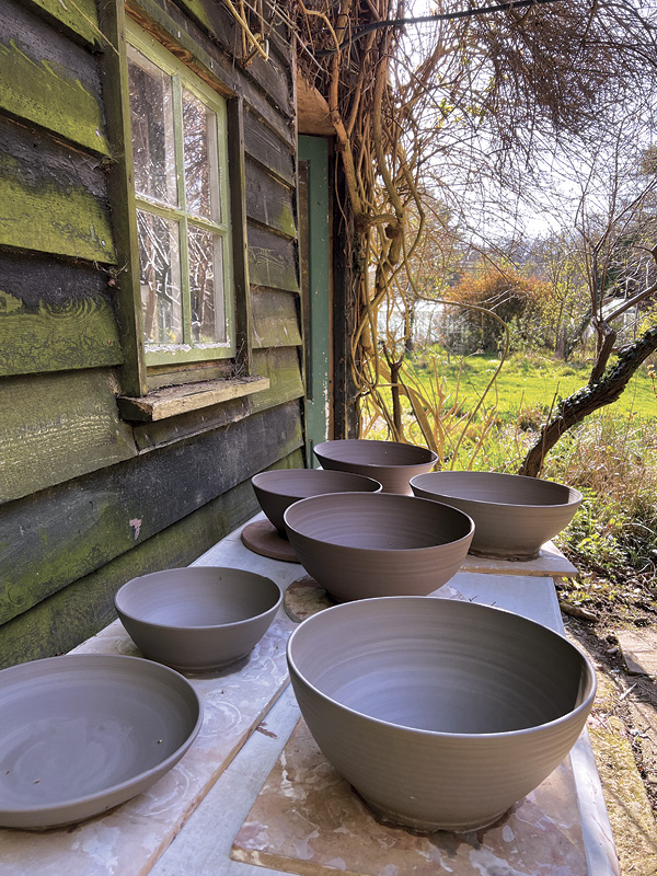 5 With limited space inside the studio, Sampson utilizes outdoor spaces to store freshly thrown and trimmed work.