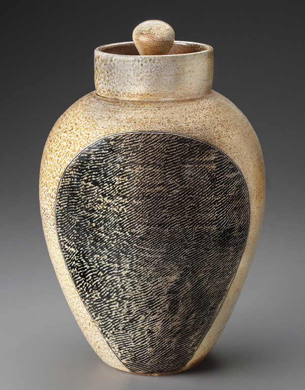 1 Large thumbprint canister, 15 in. (38 cm) in height, white stoneware, black slip, salt glazed and wood fired to cone 10, 2022. Photo: John Polak.