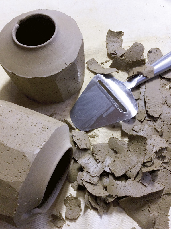 4 Faceting leather-hard, wheel-thrown, lidded containers with a cheese slicer.