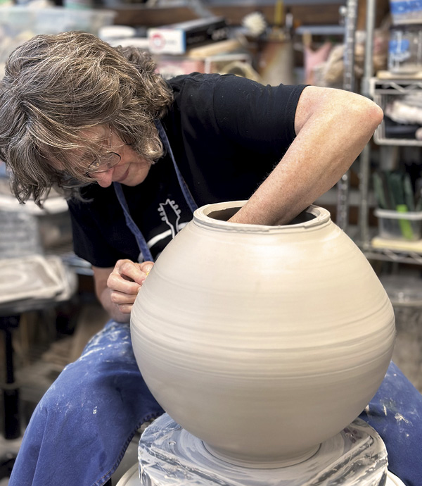 7 Judi Harwood at the wheel in her studio at The Village Potters Clay Center.