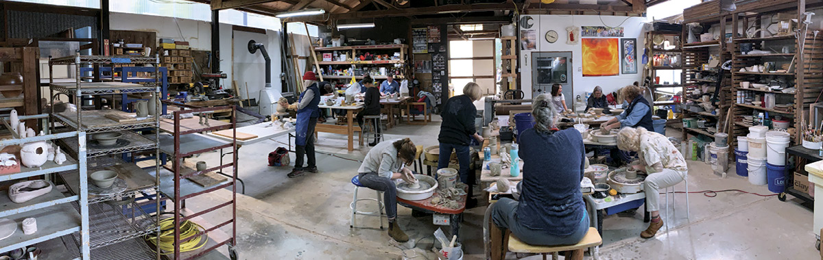 1 Summer 2022 workshop participants in 5000-square-foot studio, which also accommodates a glass studio and a metal shop. Equipment includes seventeen wheels and six electric kilns. Photo: Joe Robinson.