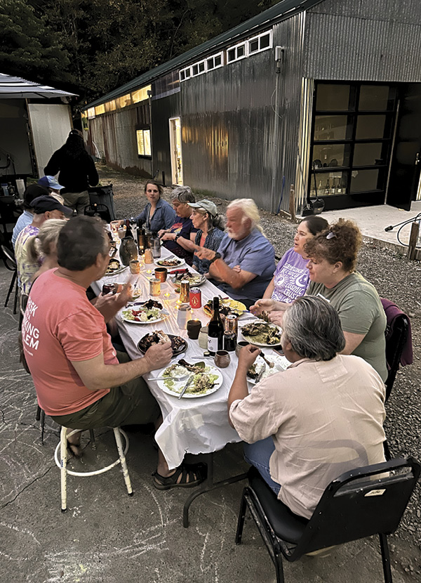6 Participants share dinner with artist Polo Ramirez during a workshop he taught on Peruvian stone-and-paddle building methods, August 2023. Photo: Joe Robinson.