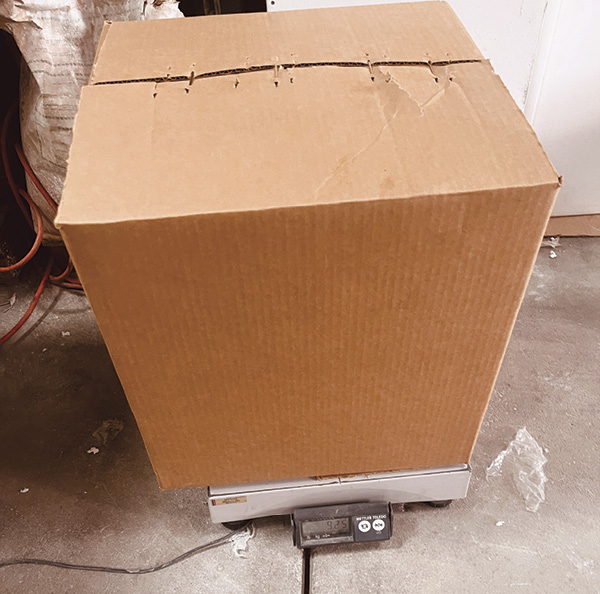 7 Place a layer of filler flats on top of the interior box, then staple the exterior box before weighing.