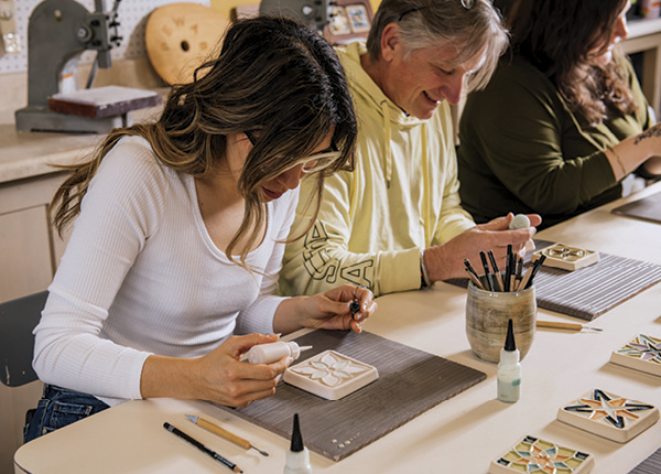 4 Participants glaze tiles during a Pewabic Pottery workshop. Photo: EE Berger.