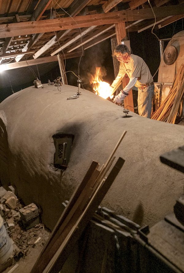 3 Roger Jamison side stoking his anagama kiln in Juliette, Georgia. Photo: Ken Krakow.