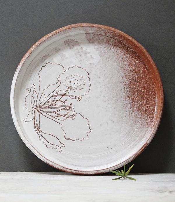1 Vallari Harshwal’s Under the Gulmohar Tree Plate, 9 in. (23 cm) in diameter, terra cotta, white slip, transparent glaze.