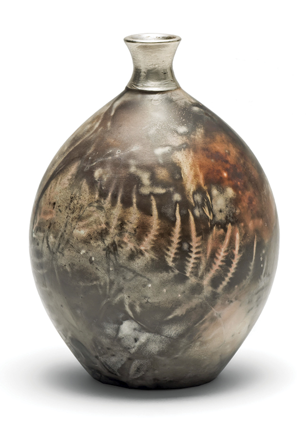 3 Alison West’s vessel, 5 1/2 in. (14 cm) in height, porcelain, terra-sigillata slip, saggar fired with organic materials in a gas kiln, silver clay top.