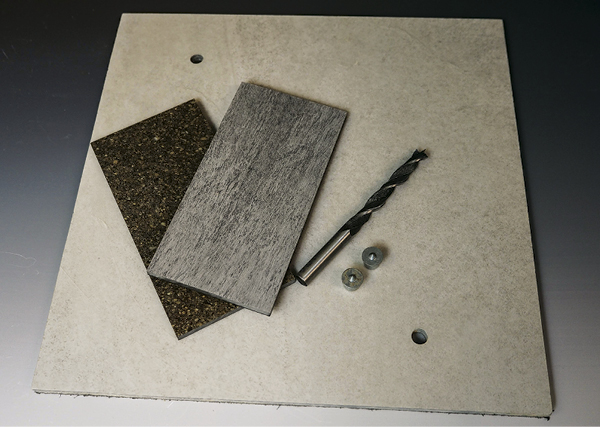1 A square bat with sample tiles, 3/8-inch dowel centers, and a 3/8-inch brad-point drill bit.